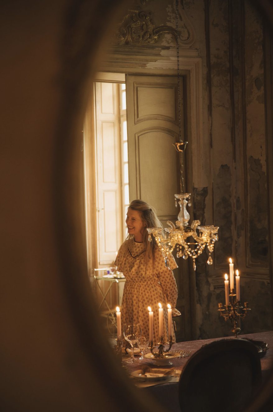 By the window, the candles lit