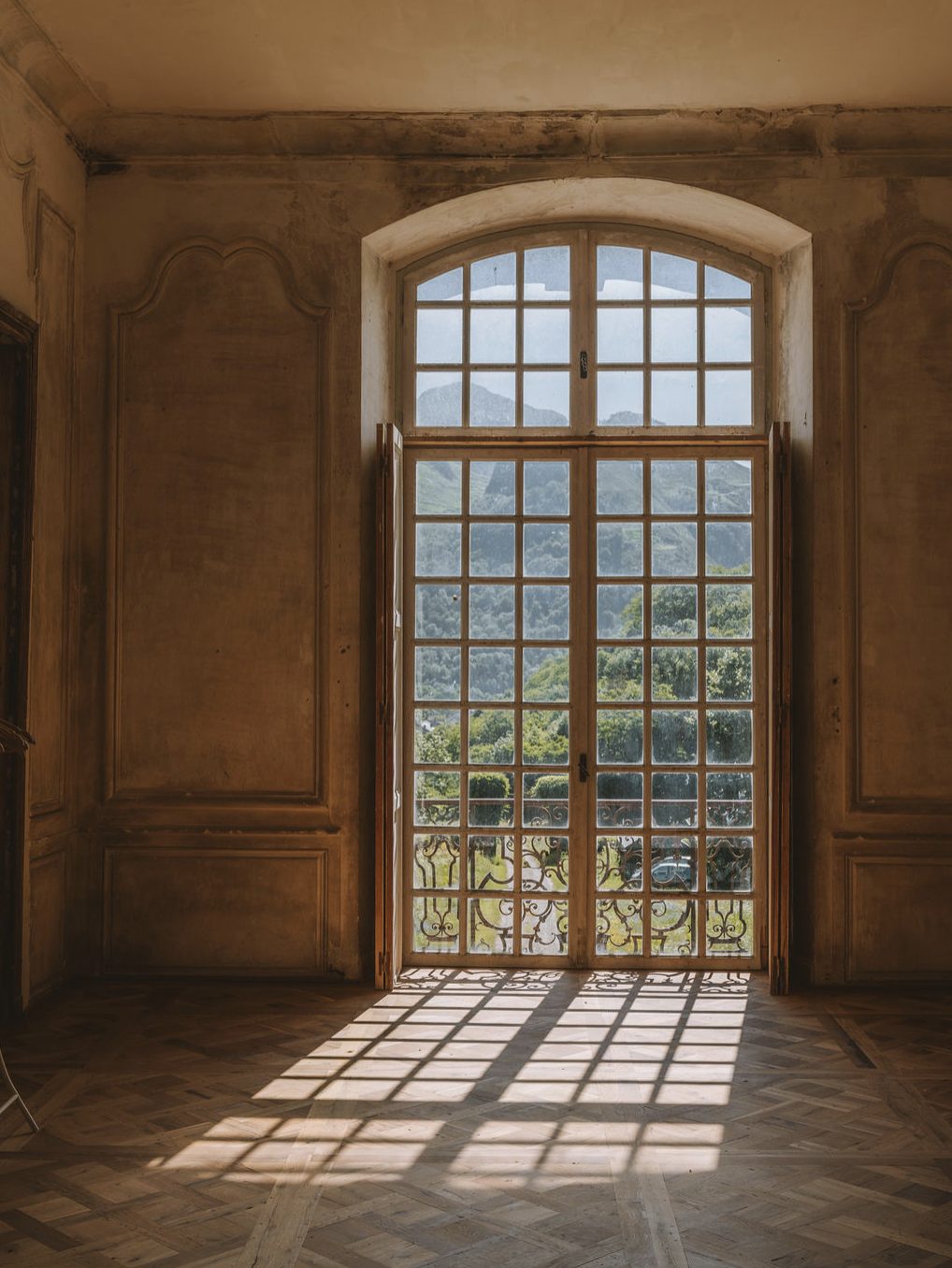 A tall window, the mountains beyond
