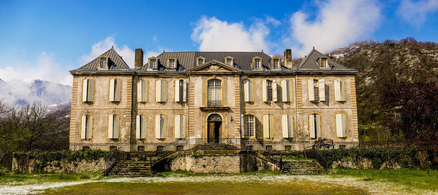 The château, snow on the peaks behind
