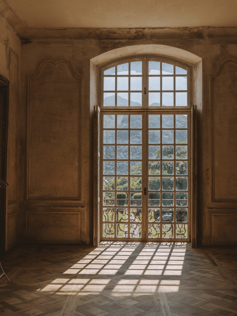 A tall window, the mountains beyond