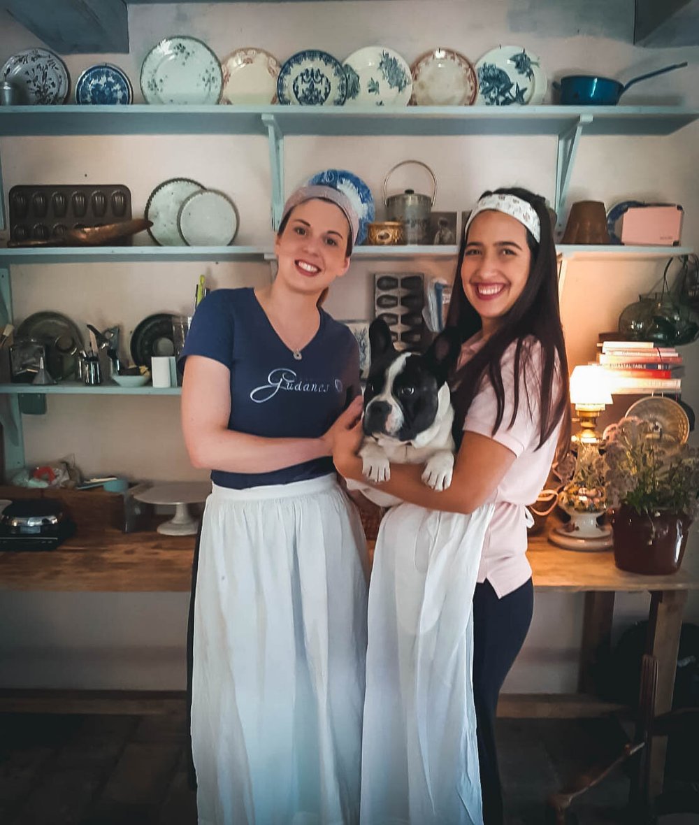 Two of the team in aprons in the pastry kitchen, holding Bruce