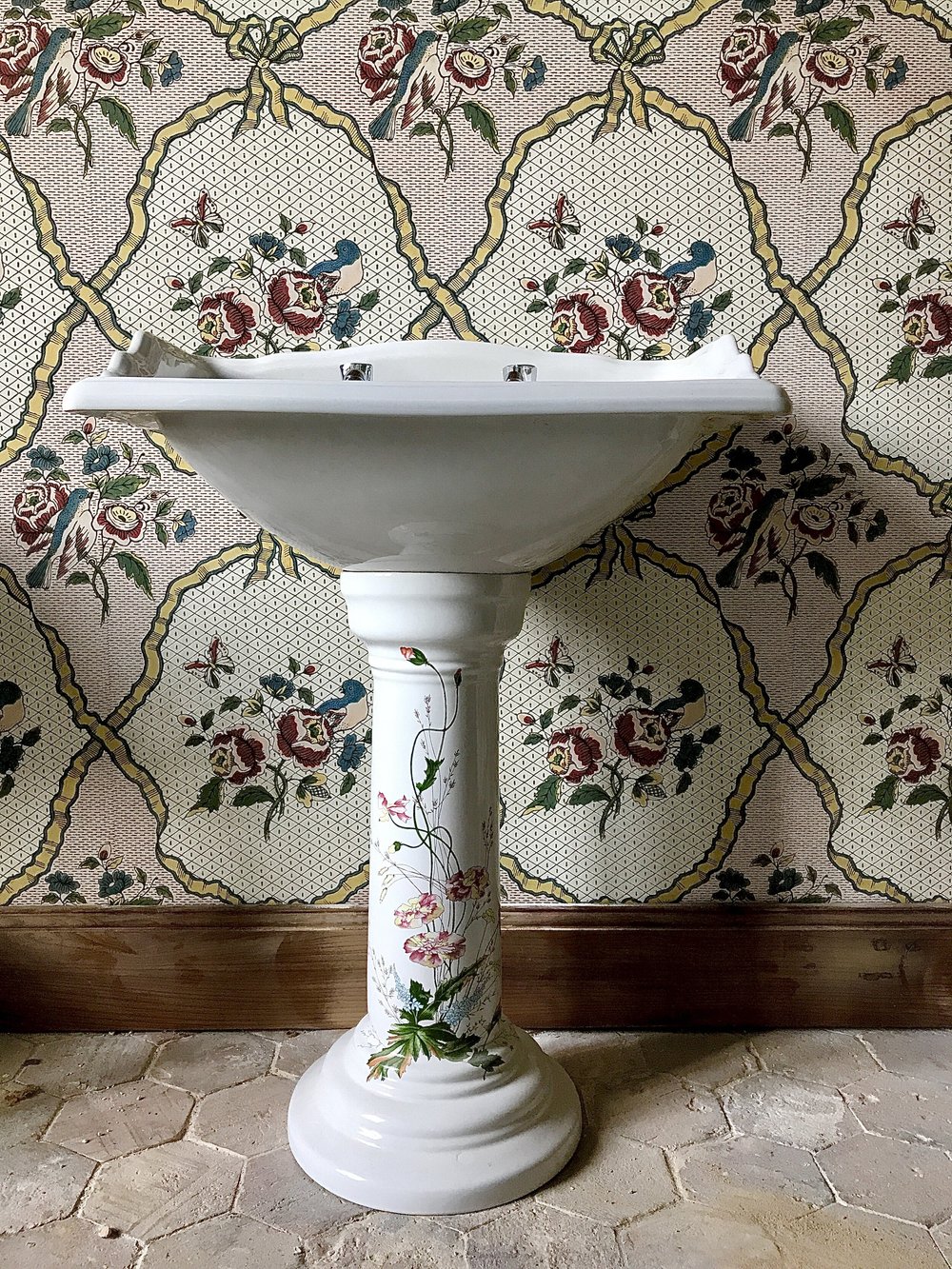A hand-painted basin on the reclaimed terracotta