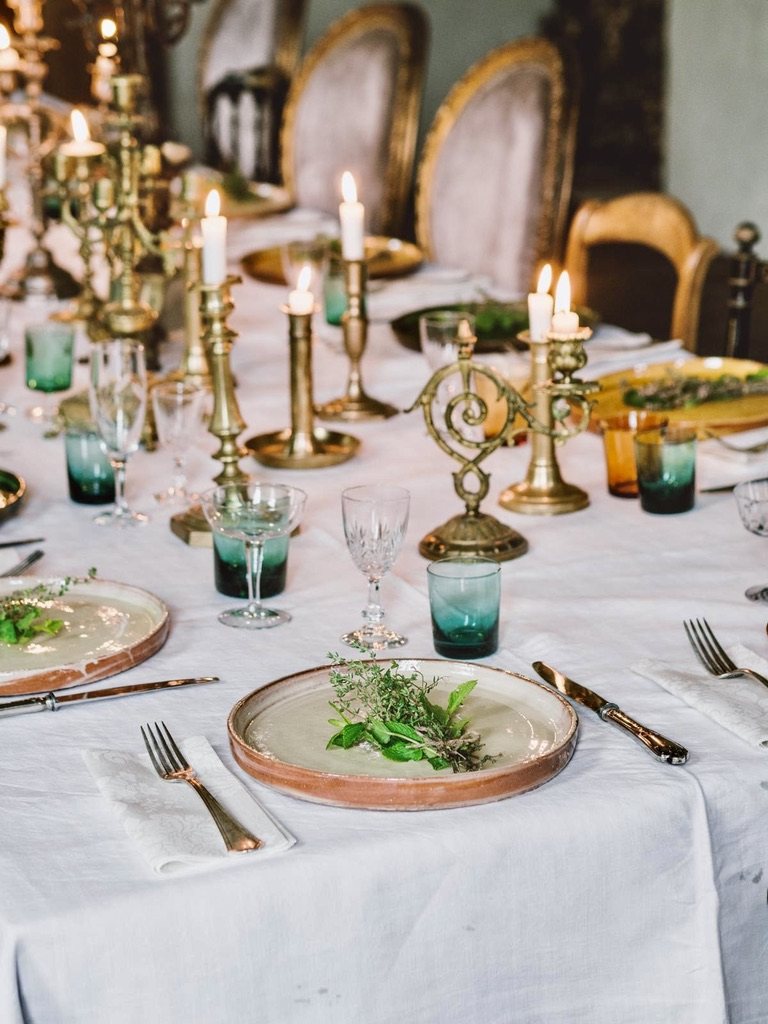 Candelabra and green glasses at each place