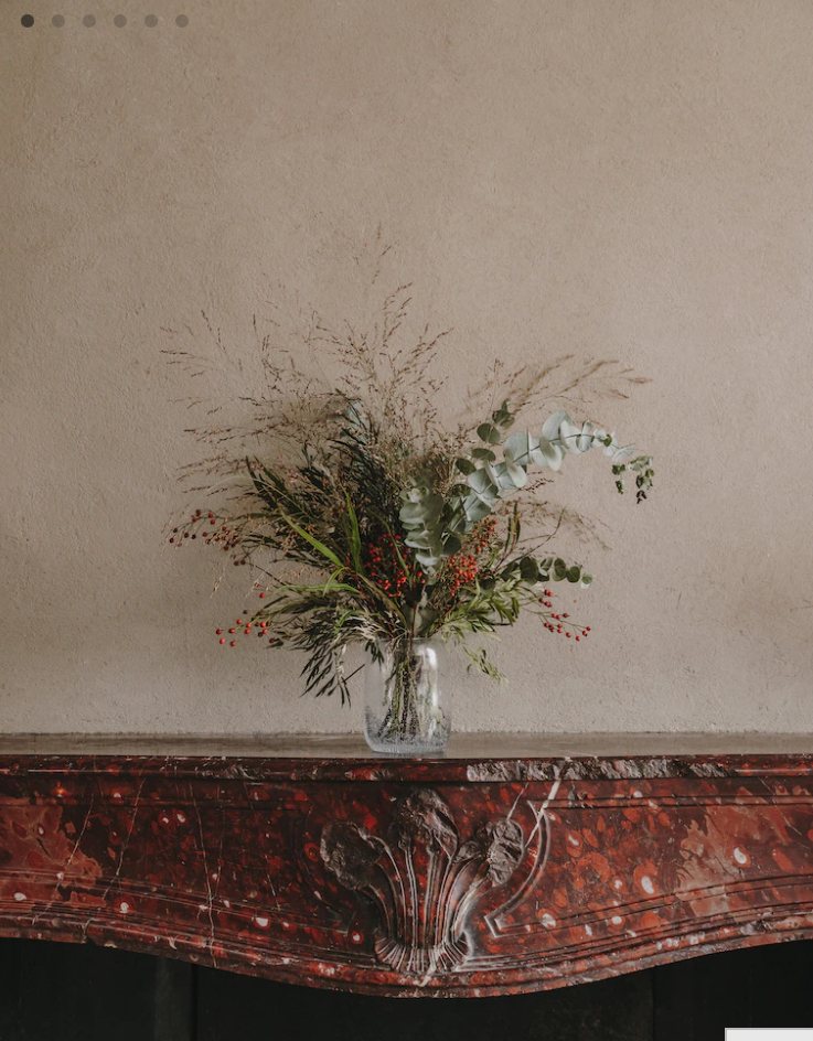 Dried flowers on the red marble mantel