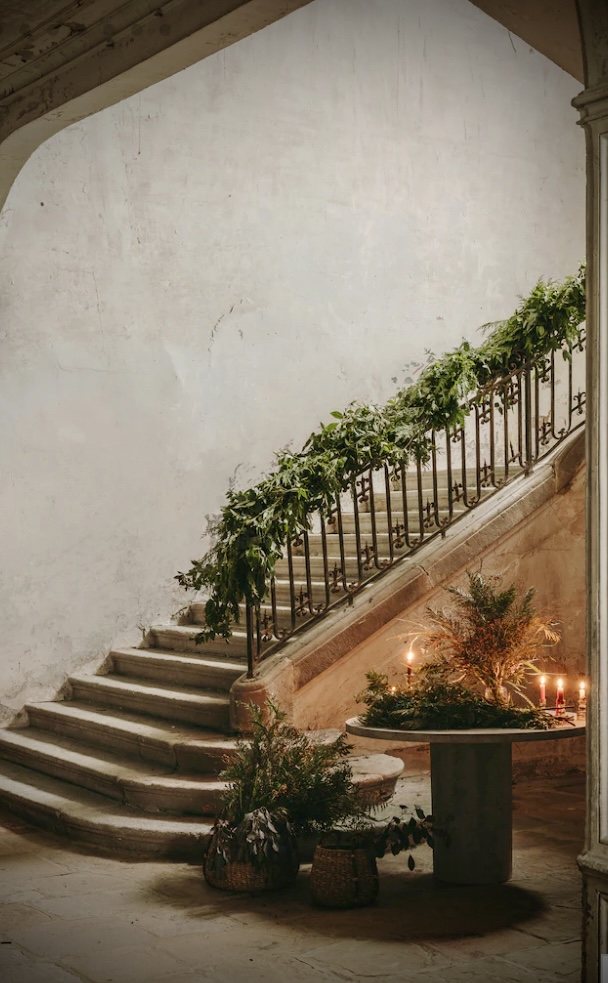 The staircase, dressed with a garland and candles