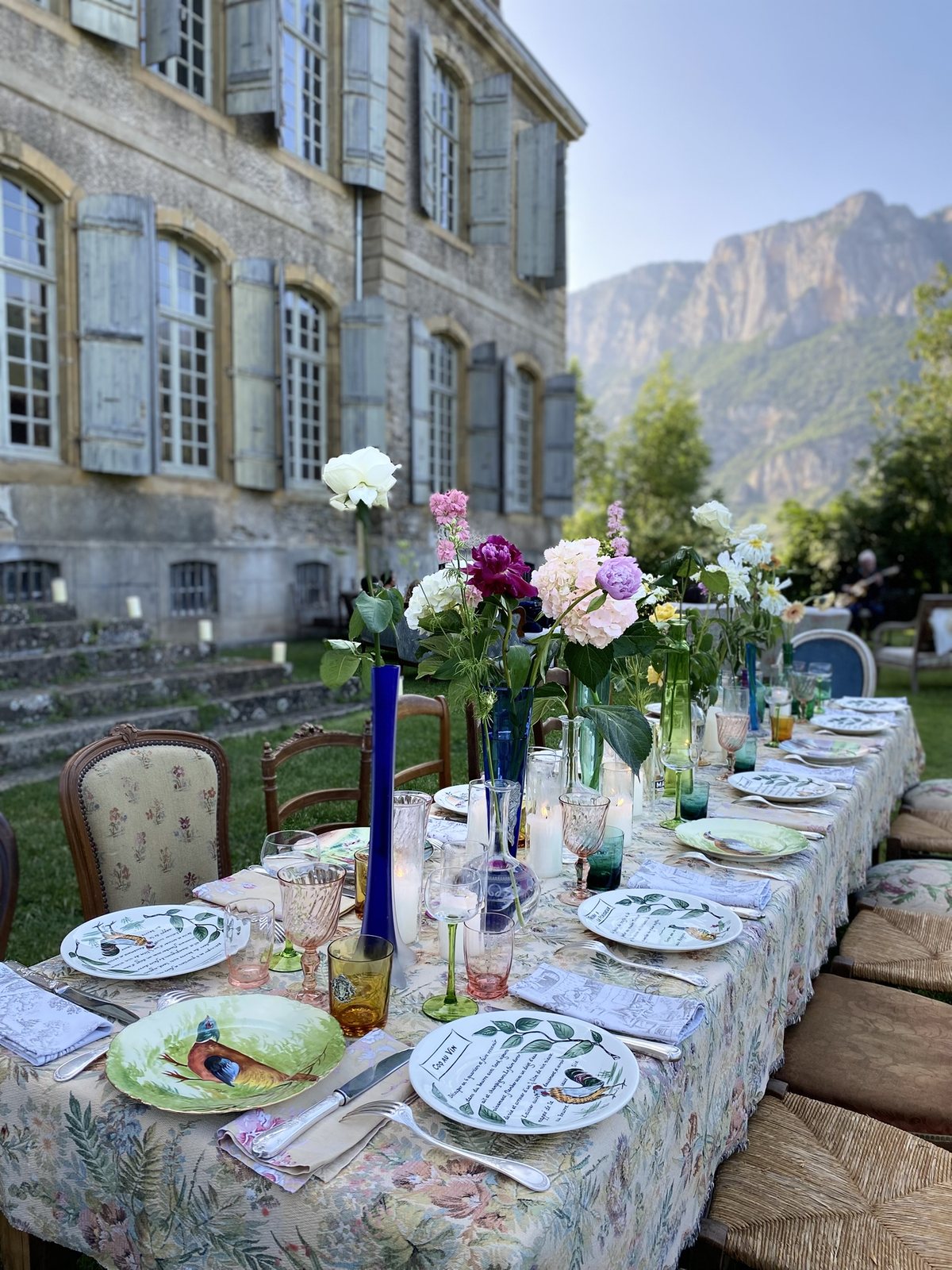 A long table on the terrace, the mountains beyond