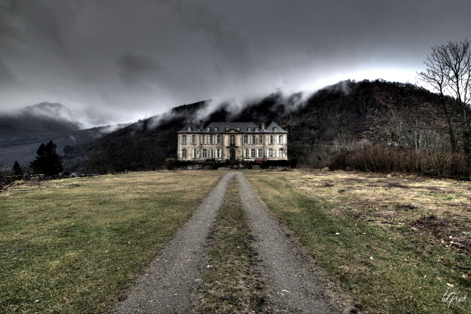 The drive under a storm sky