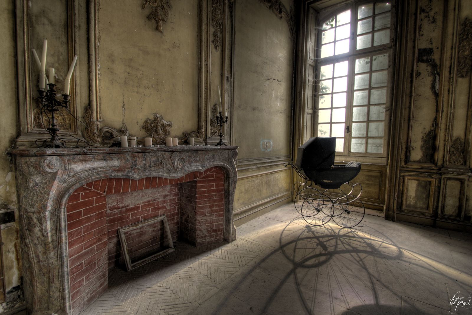 A marble fireplace and an old pram
