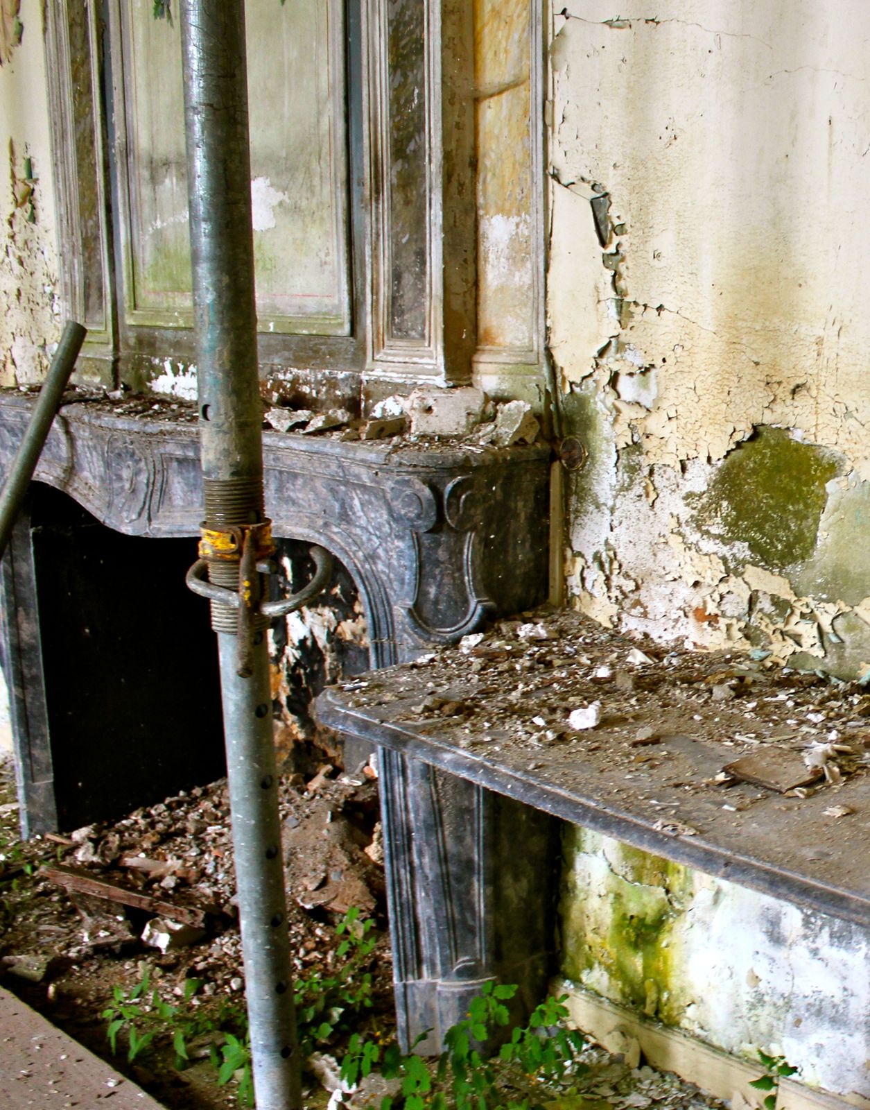 A fireplace among the props and the moss