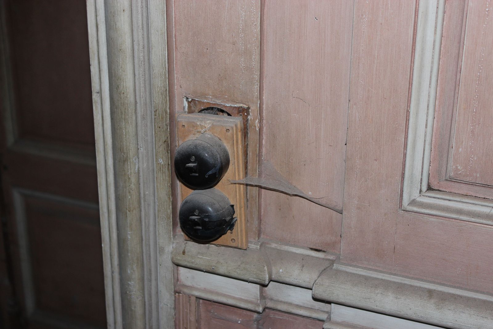 Old switches on a panelled wall