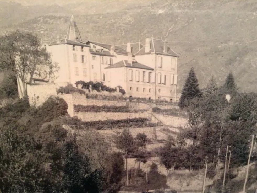 The château above its terraced gardens, in an early photograph