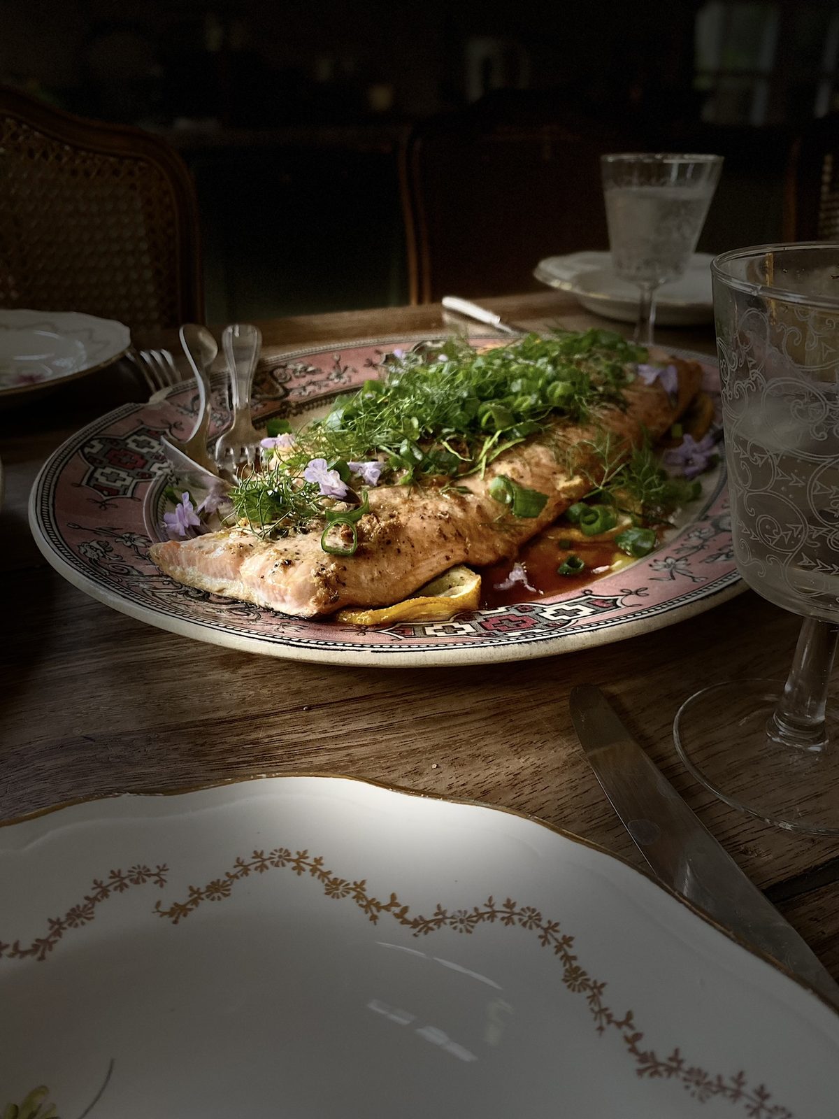 Fish with herbs on a floral plate