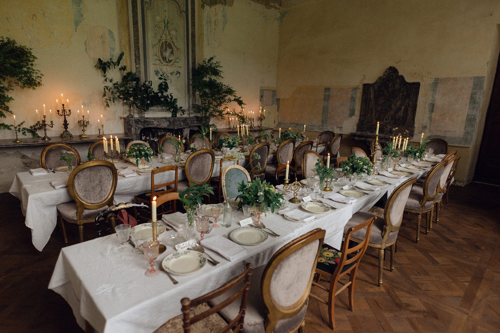 The long table by candlelight, laid for a celebration