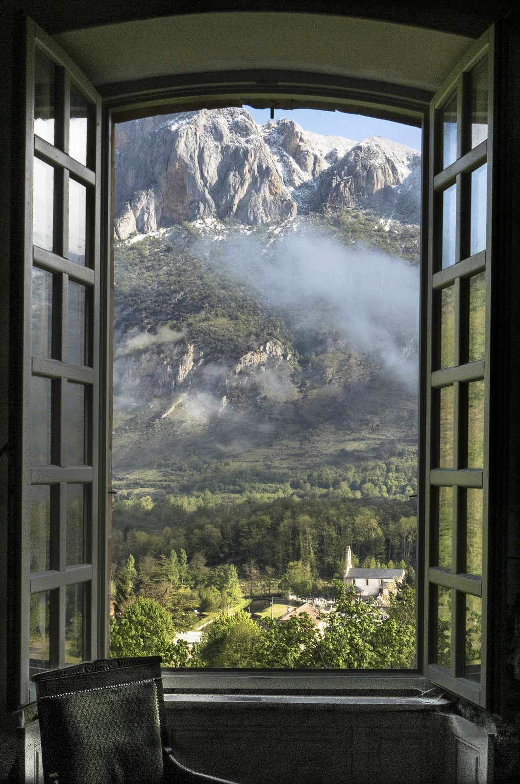 Mist on the mountain, a chair by the window