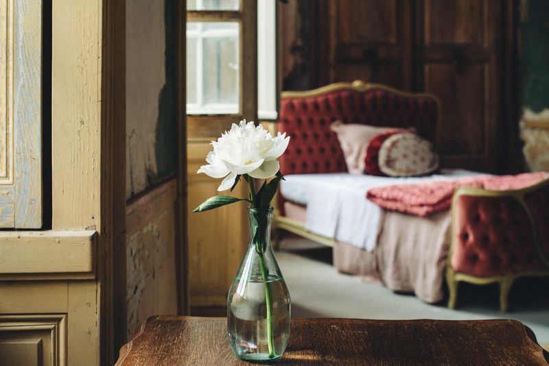 A bedroom made ready, with a peony