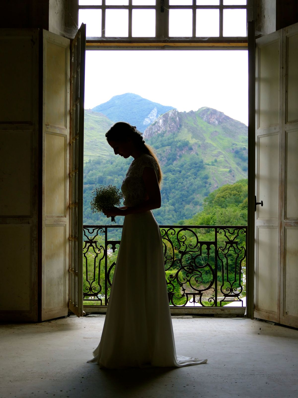A bride at the window, the mountains beyond