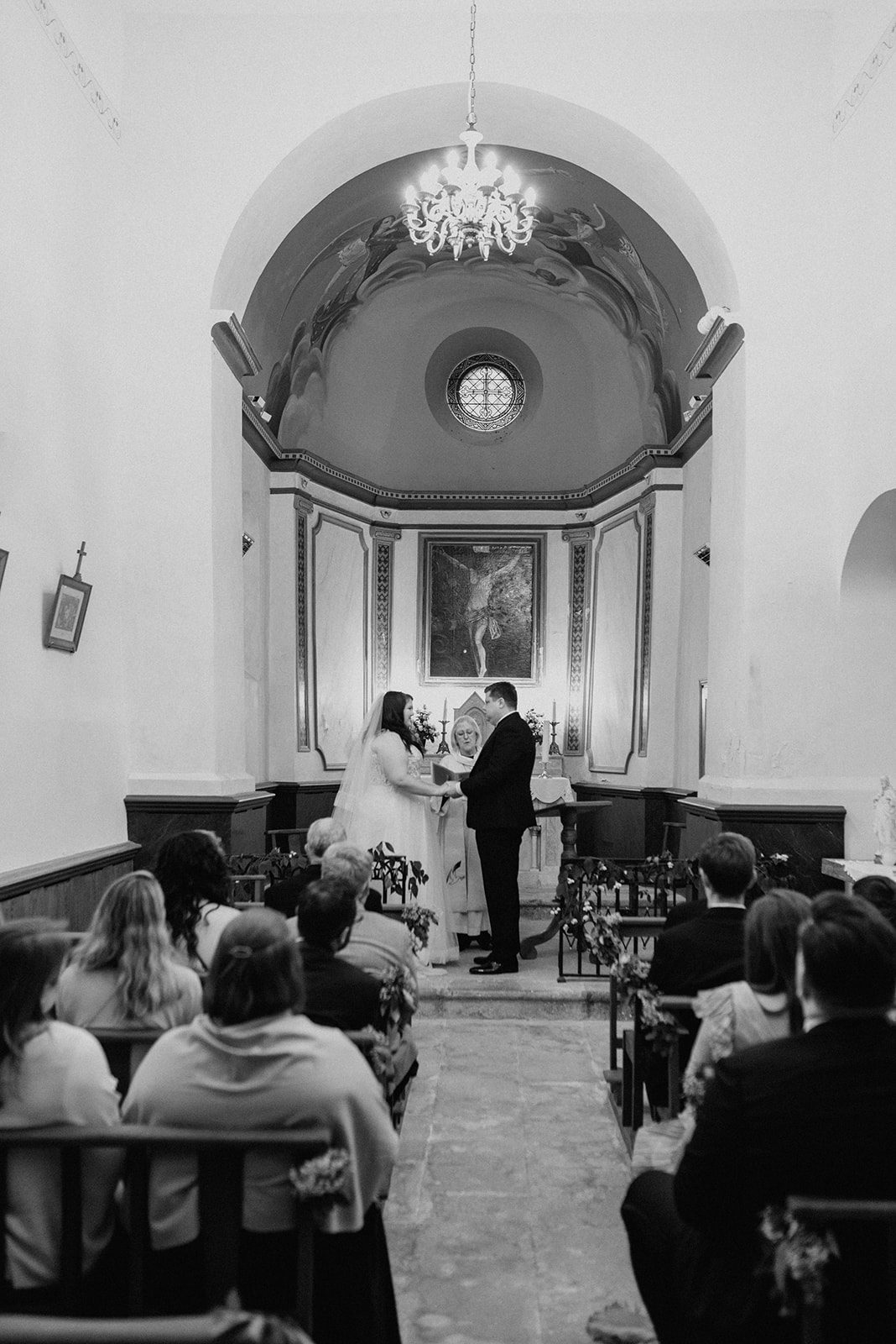 A wedding ceremony in the local church, seen from the back
