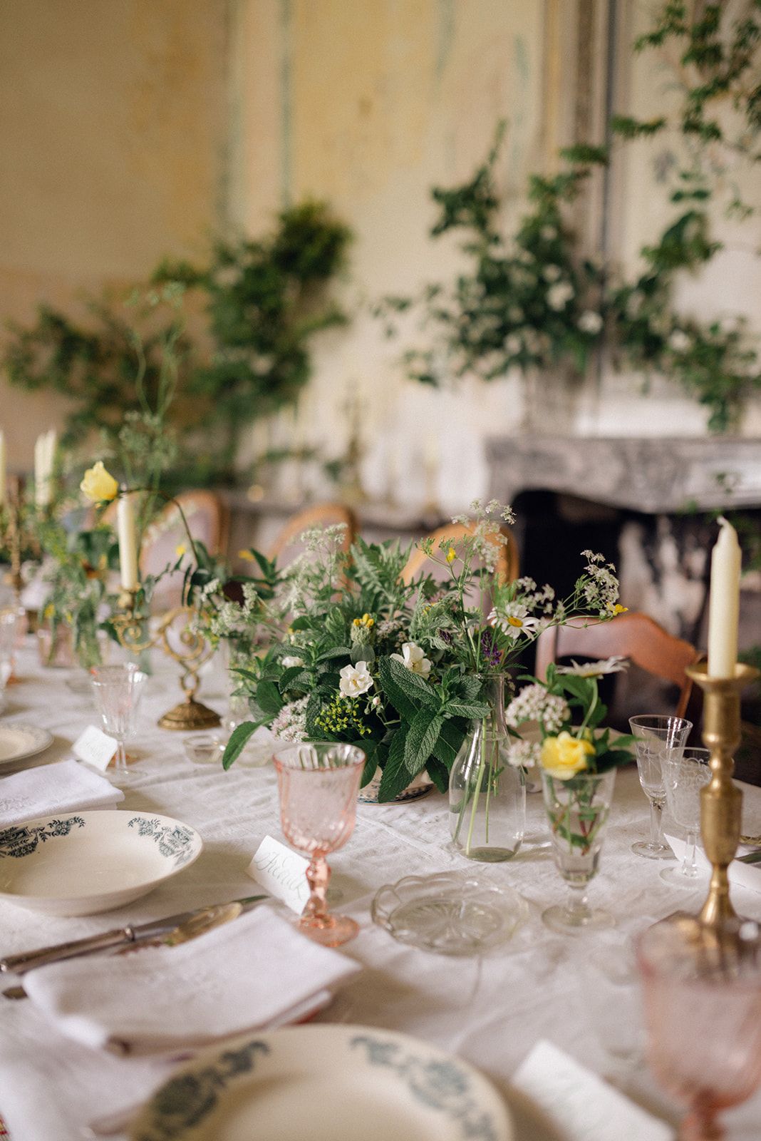Flowers and rose-pink glasses on the table