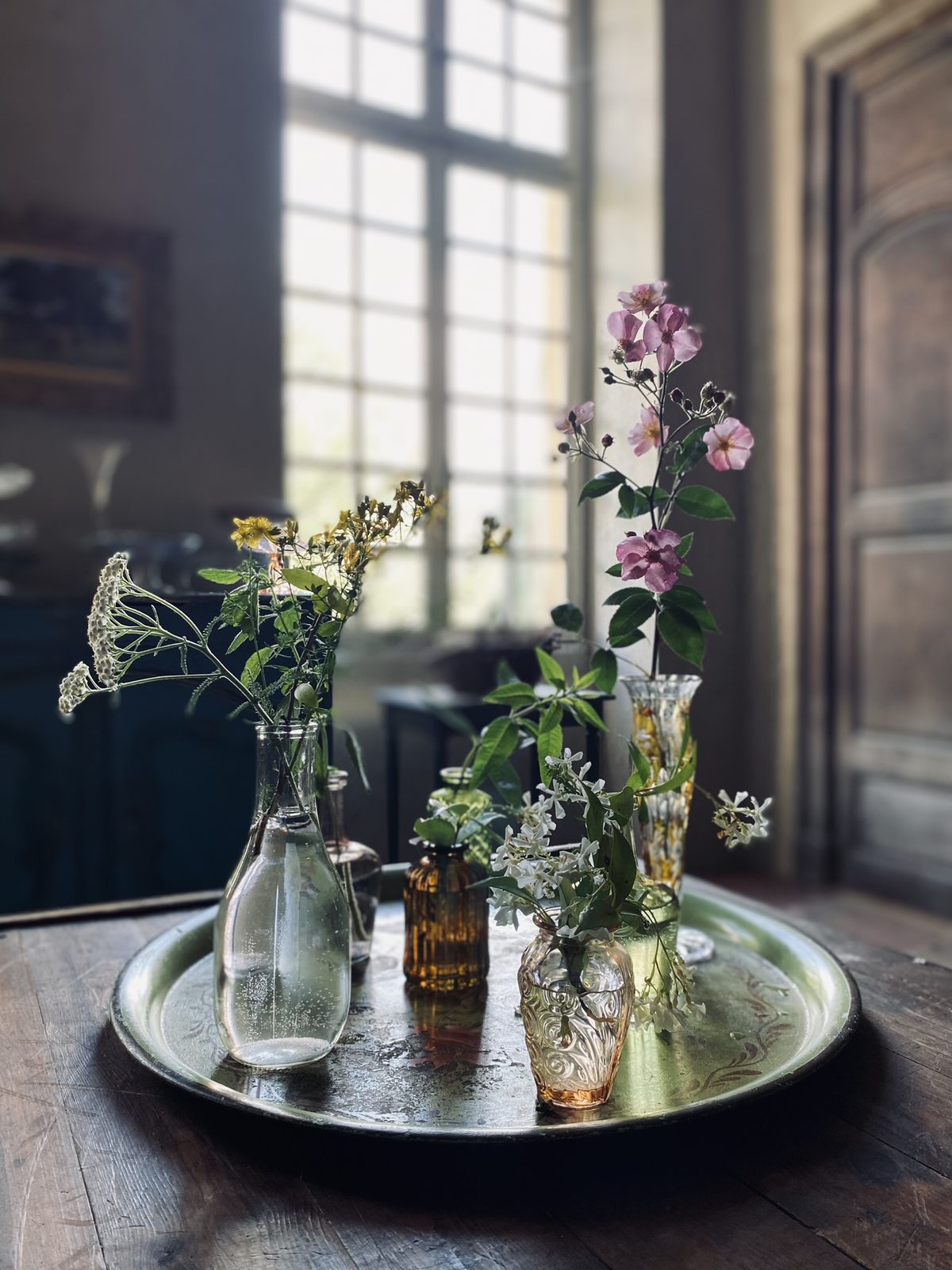 Flowers on a silver tray by the window