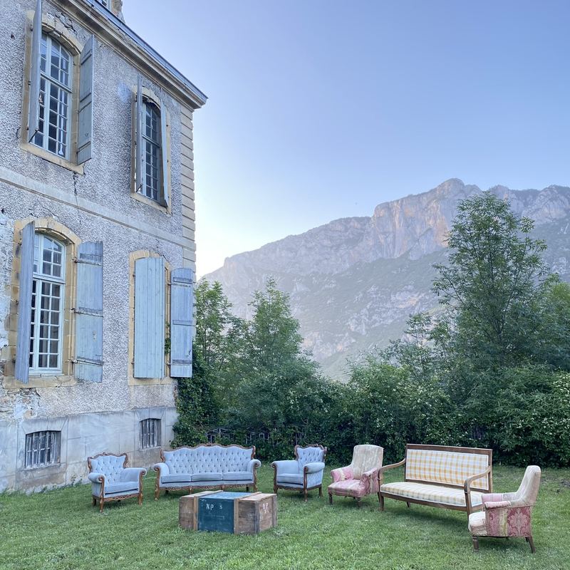 Sofas on the lawn, facing the mountains