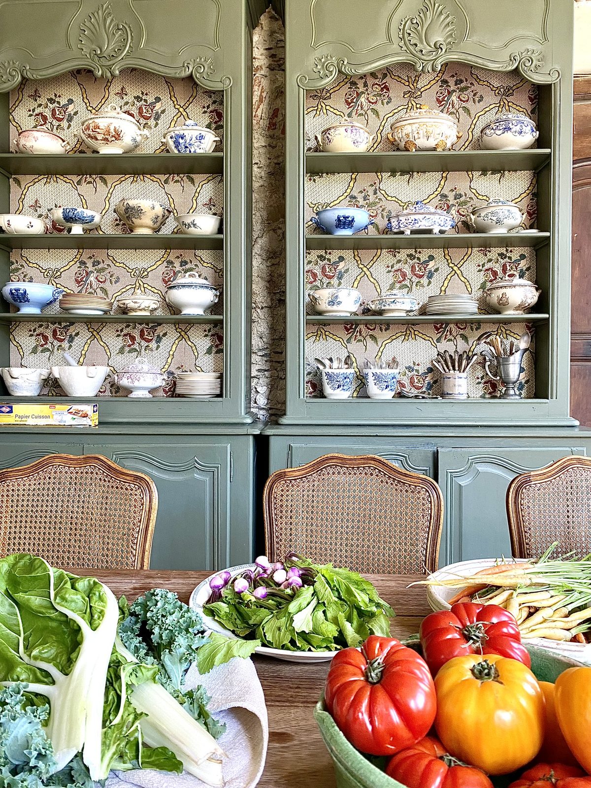 The green dresser, vegetables on the table