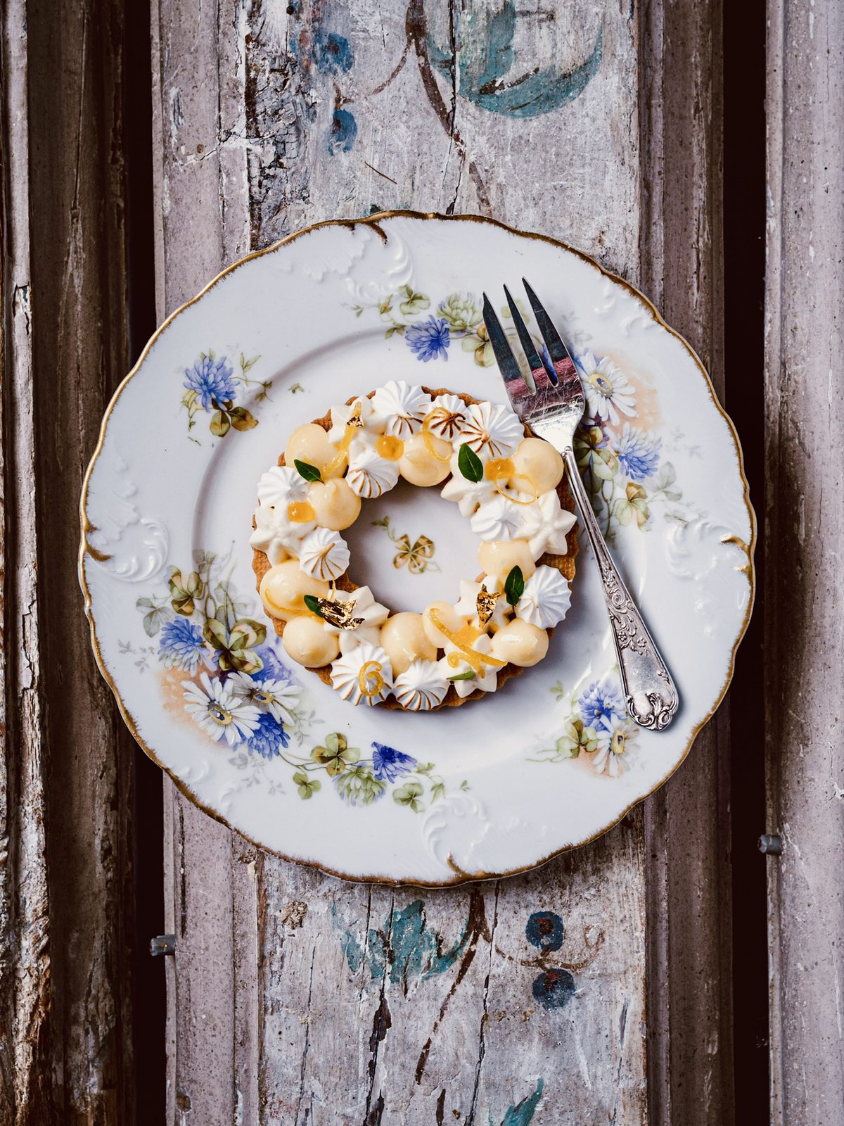 A pastry wreath on a floral plate