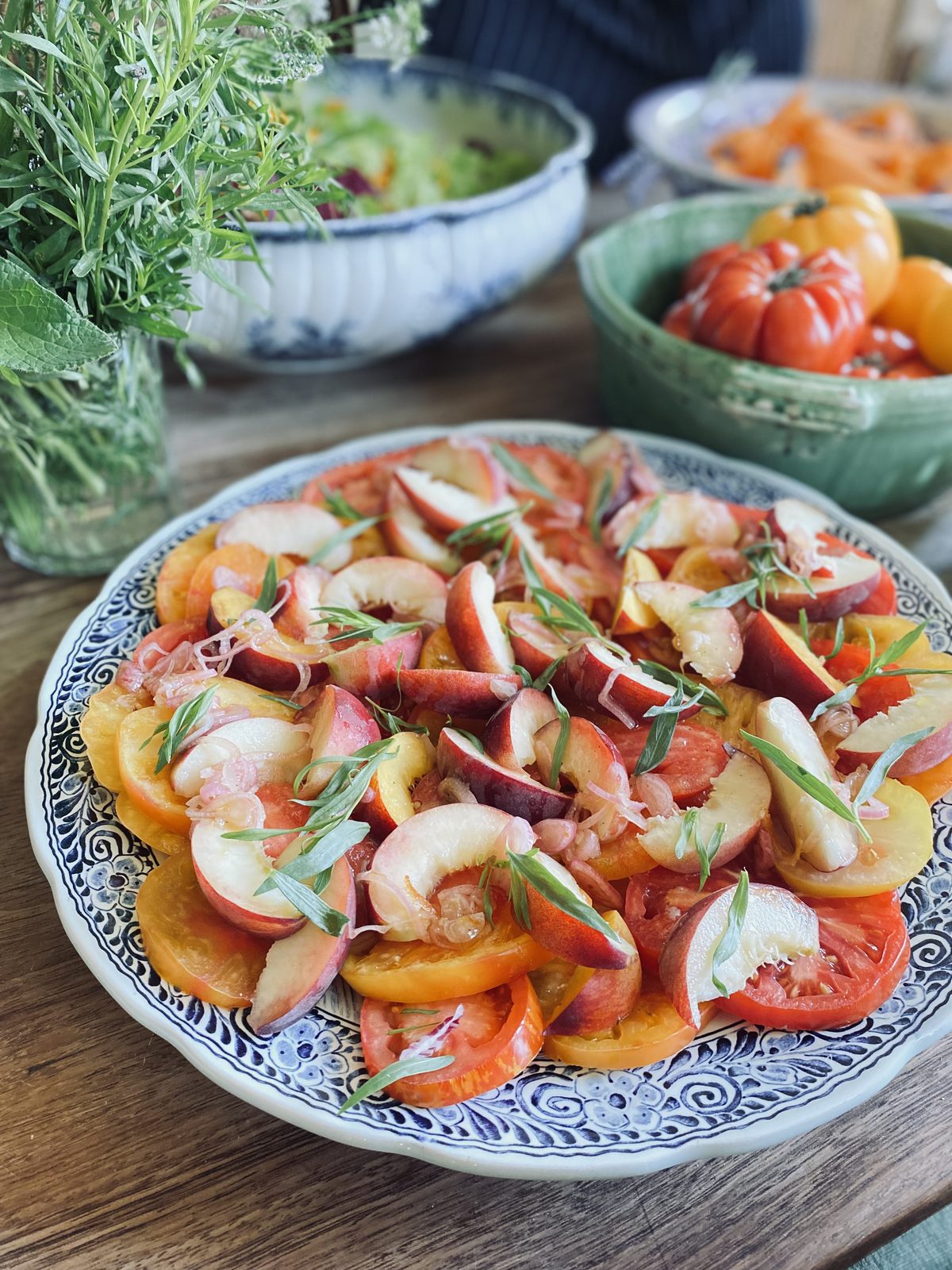 Tomatoes and peaches on blue-and-white china